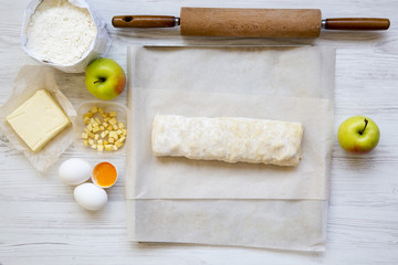 Raw apple pie or strudel with ingredients, from above. Flat lay. Top view.