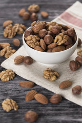 Mixed nuts - hazelnuts, walnuts, almonds in white bowl