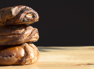 three buns on a wooden background