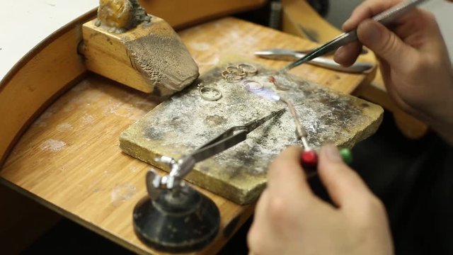 Production and making silver ring jewelry jewels ring jeweler workshop in master hand work