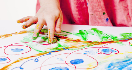 Naklejka premium little girl learning to paint with fingers (child development in art)