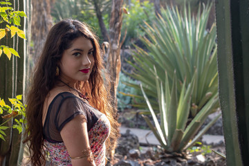 Young latina student posing in a cactus botanical garden