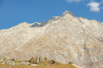 'Selective focus' A beautiful view of Dhauladhar Mountain ranges during a sunny day and some clouds. Triund, Himachal Pradesh. India