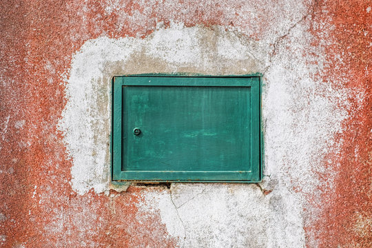 small metal gate on grunge wall - Powered by Adobe