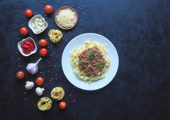 Pasta with bechamel sauce on a black background.