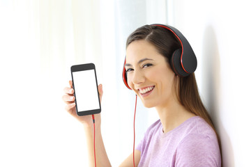 Girl listening to music and showing phone screen