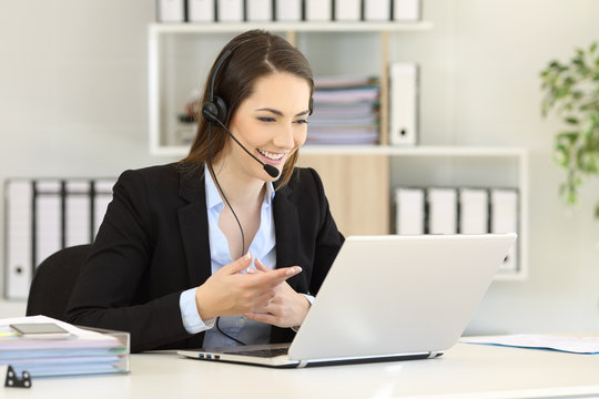 Teleoperator talking online with clients at office