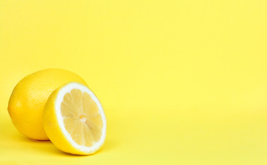 Ripe whole lemon citrus fruit with lemon fruit half