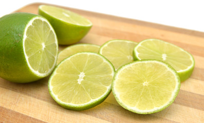 Fresh ripe lime isolated on wooden board