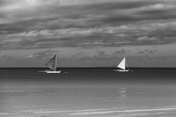 Double outrigger sailboats on the sea