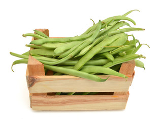 green beans in wooden crate on white background