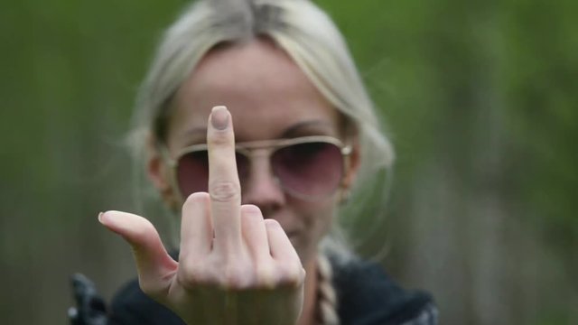 Fuck You , blonde girl shows Fuck You and builds faces.