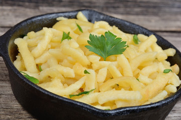 Spaetzle with butter and parsley in a iron pan