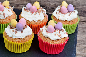 Cupcake  with chocolate eggs and cream on slate