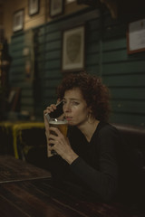 Woman having a beer at a bar