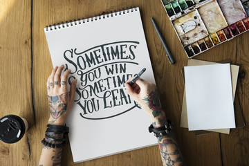 A woman is writing a motivation quote