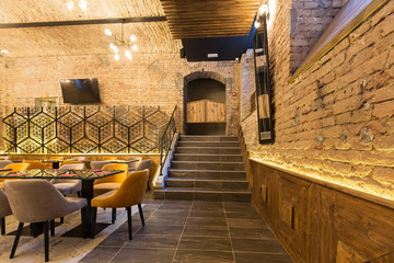 Plakat Interior of a modern hotel restaurant with brick wall