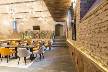 Interior of a modern hotel restaurant with brick wall