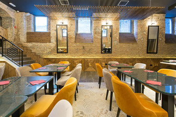 Interior of a modern hotel restaurant with brick wall