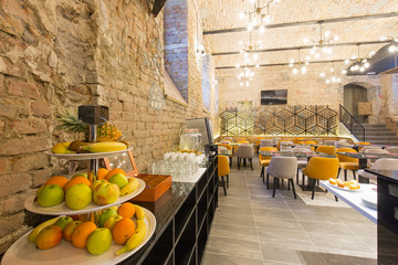 Interior of a modern hotel restaurant with brick wall