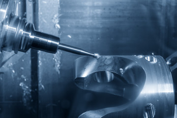 The table-spindle tilt type 5-axis CNC milling machine cutting the aluminium sample part with solid ball endmill in the light blue scene.