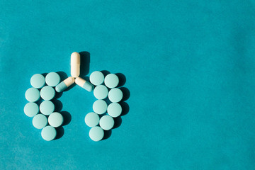 on a blue background from tablets the form of human lungs is laid out. The concept of a cure for lung
