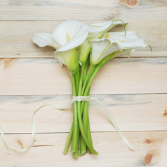 Bunch of Cala Lilies Flower summer Bouquet over Wooden Background Square Image