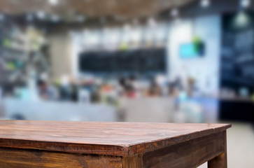 Fototapeta na wymiar Selected focus empty brown wooden table and Coffee shop or restaurant blur background with bokeh image. for your photomontage or product display.
