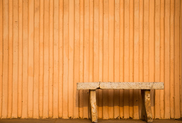 The bench, which is sitting on an orange background.