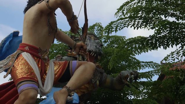 slow motion close up of a rotating ogoh-ogoh statue on a kuta street of bali