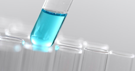 Pipette dropping the liquid into test tube