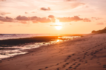 Fototapeta na wymiar Tropical sandy beach and sunset or sunrise colors