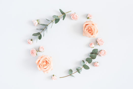 Flowers composition. Wreath made of rose flowers, eucalyptus branches on pastel gray background. Flat lay, top view, copy space