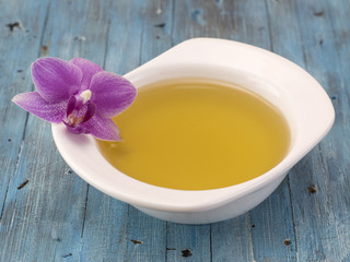 olive oil on a blue wooden background. 
