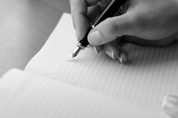 
Woman (girl, bussineswoman) hand with pen writing on notebook. 