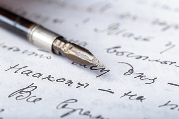 Fountain pen on an antique handwritten letter
