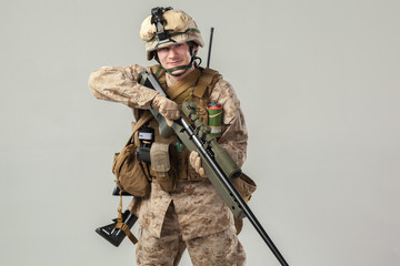 Soldier in camouflage holding rifle