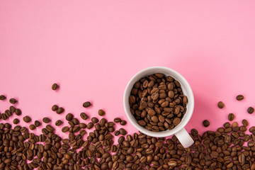 Coffee beans on a pink backround copy space