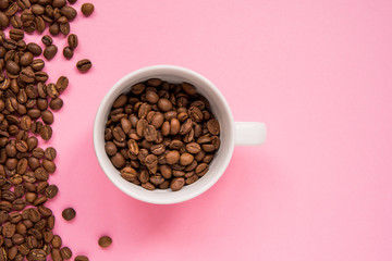 Coffee beans on a pink backround copy space