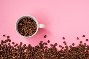 Coffee beans on a pink backround copy space