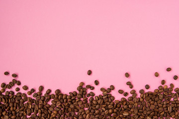 Coffee beans on a pink backround copy space