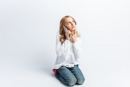 Beautiful teen girl talking on mobile phone, photo Studio, isolated