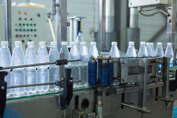Closeup on mineral water bottles in raw and lines