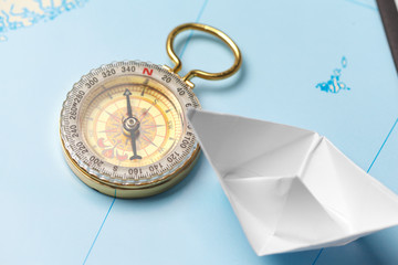 Origami paper ship on a map. Leadership and travelling concept