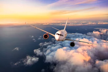 Foto op Plexiglas Passengers commercial airplane flying above clouds © Jag_cz