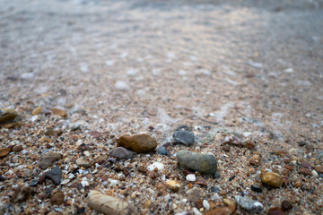Sea waves on the beach with full of stones