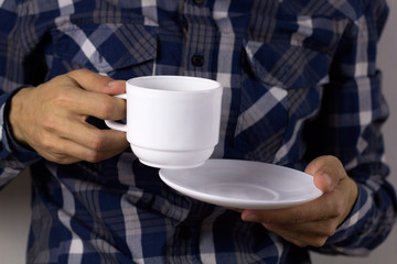 close up man's hands with cup and plate