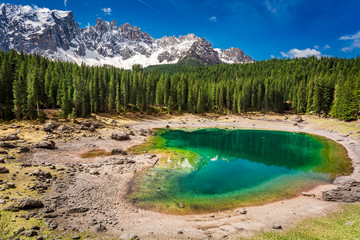 Bllue mountain Carezza lake in spring, Alps, Italy