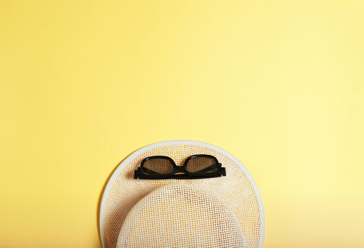 concept of leisure and travel, beach, sun hat and sunglasses on a yellow background. summer