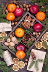 Holidays composition with christmas fruits, nuts and gift box